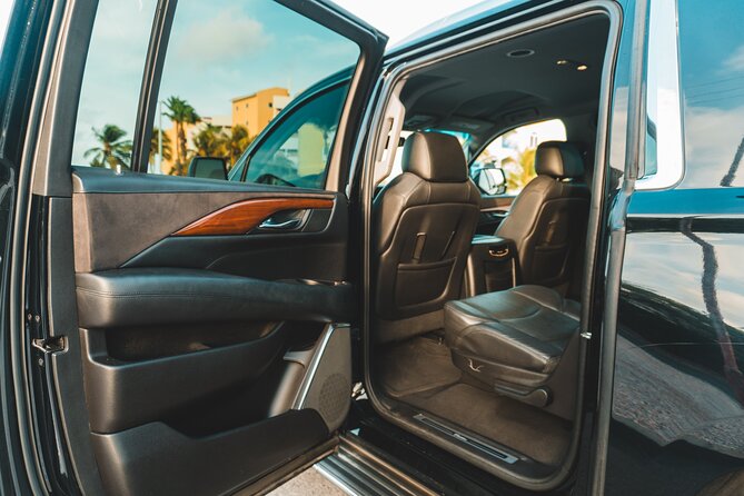 VIP Luxury SUV Airport Transfer - Reina Beatrix pickup: name sign, airport lobby, and zero guesswork